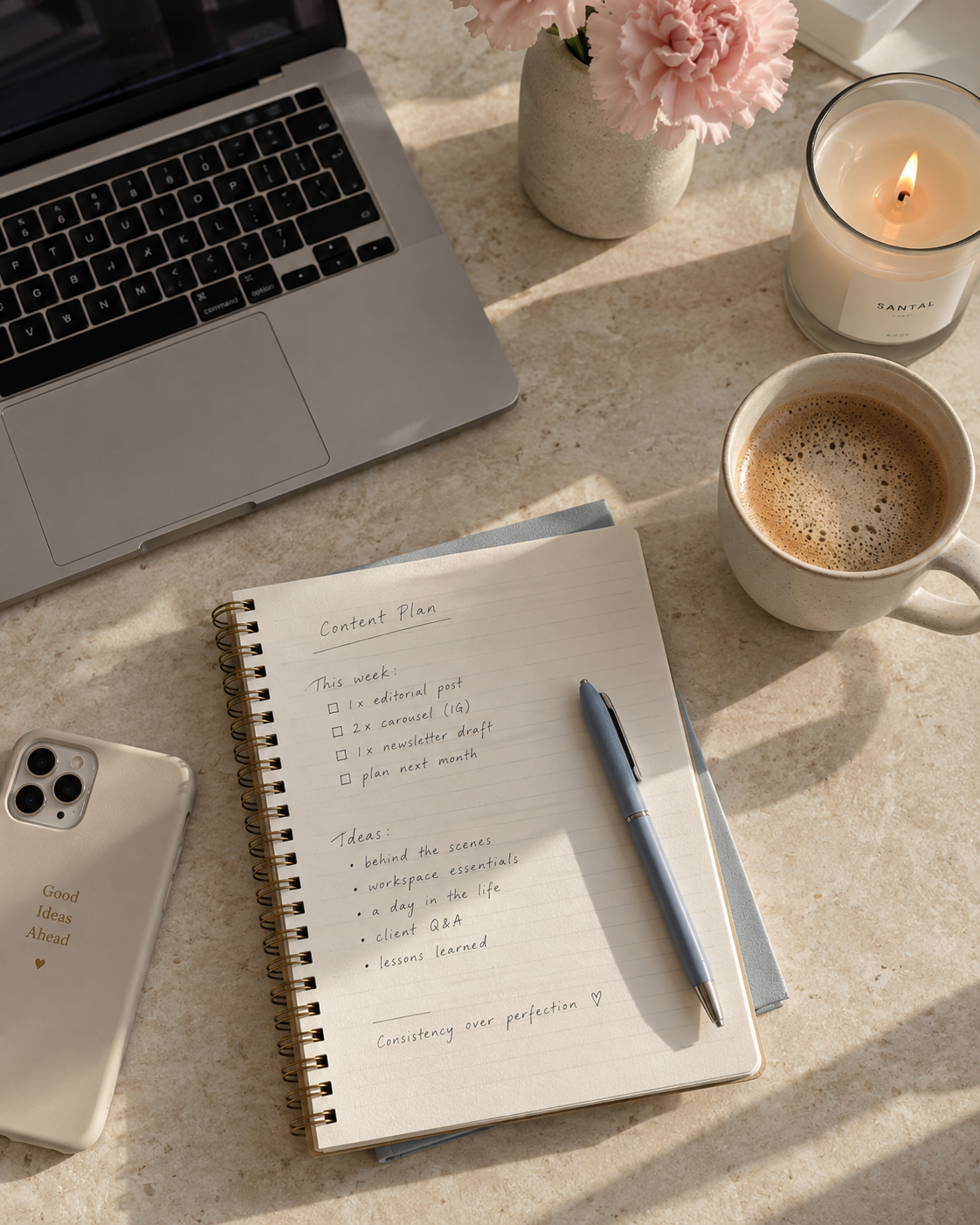 Notebook with a handwritten content list beside a phone and coffee